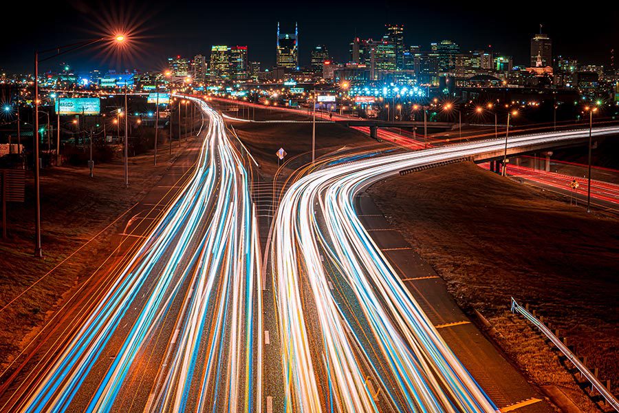 About Our Agency - Traffic Streams in and Out of Nashville, Tennessee at Night, Lights Glowing, Seen From Above