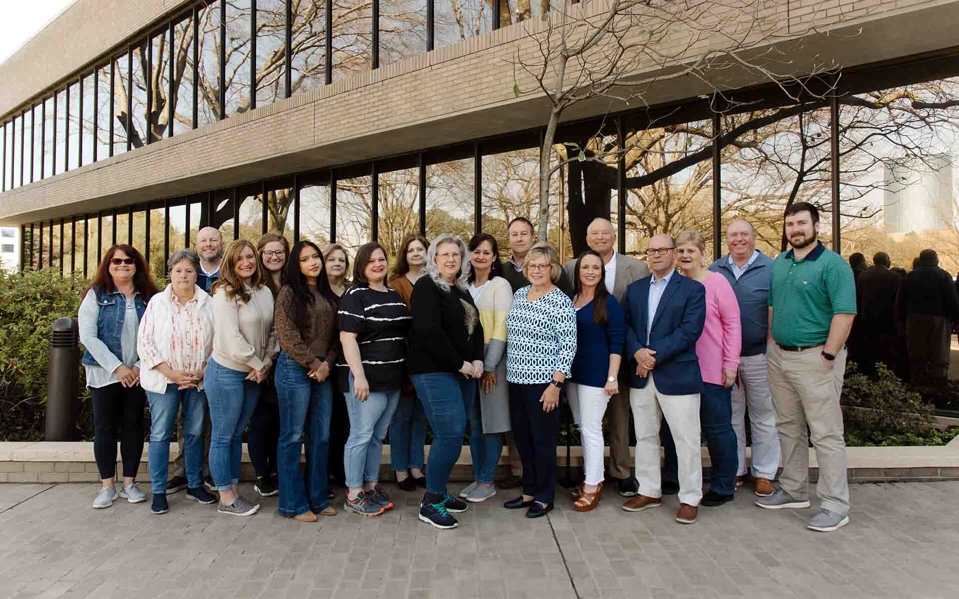 Homepage - Boyle Insurance Agency Team Members Standing Outside in Front of the Office As They Smiling and Pose Together for a Photo on a Nice Day